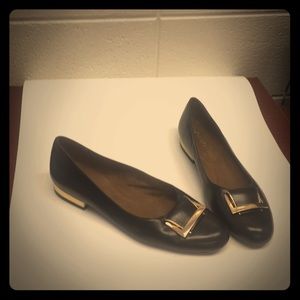 Black flats with gold buckle on toe $ gold heel.